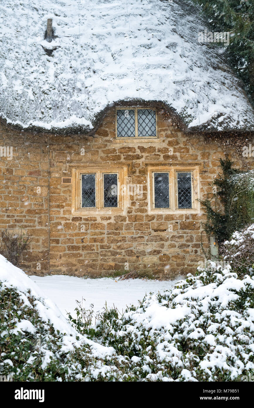 Thatched Cottage In Winter Snow High Resolution Stock Photography and