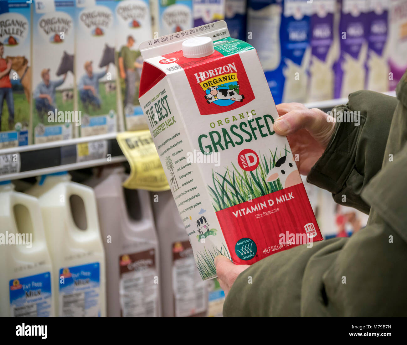 A customer chooses a half-gallon container of Horizon brand organic  grassfed milk in a supermarket in New York on Monday, March 5, 2018.  Certified grassfed milk comes from cows that spend a