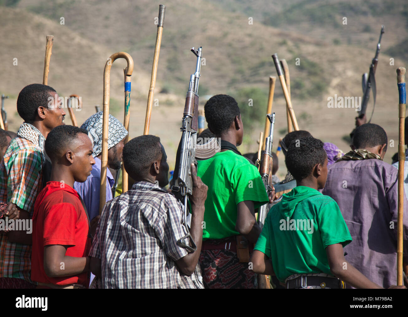 Oromo men and boys with sticks, Canes and weapons dancing and celebrating happily a wedding, Oromo region, Sambate, Ethiopia Stock Photo