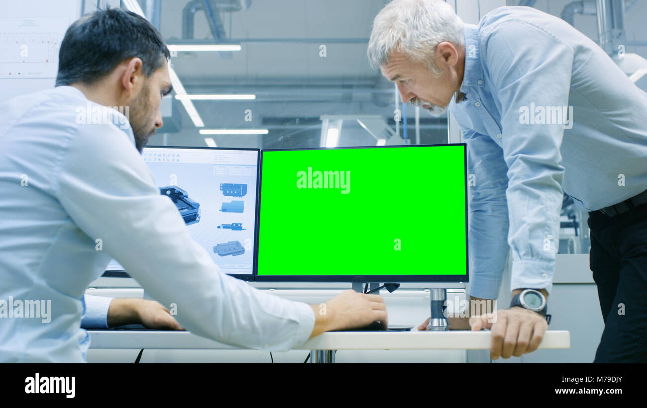 Industrial Designer Has Conversation with Senior Engineer While Working ...