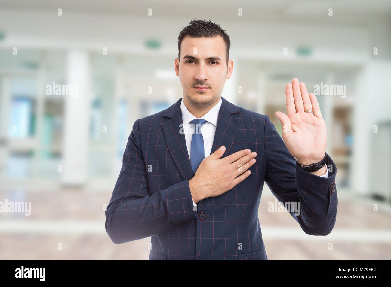 Honest trustworthy real estate agent making oath swear vow gesture on new apartment building