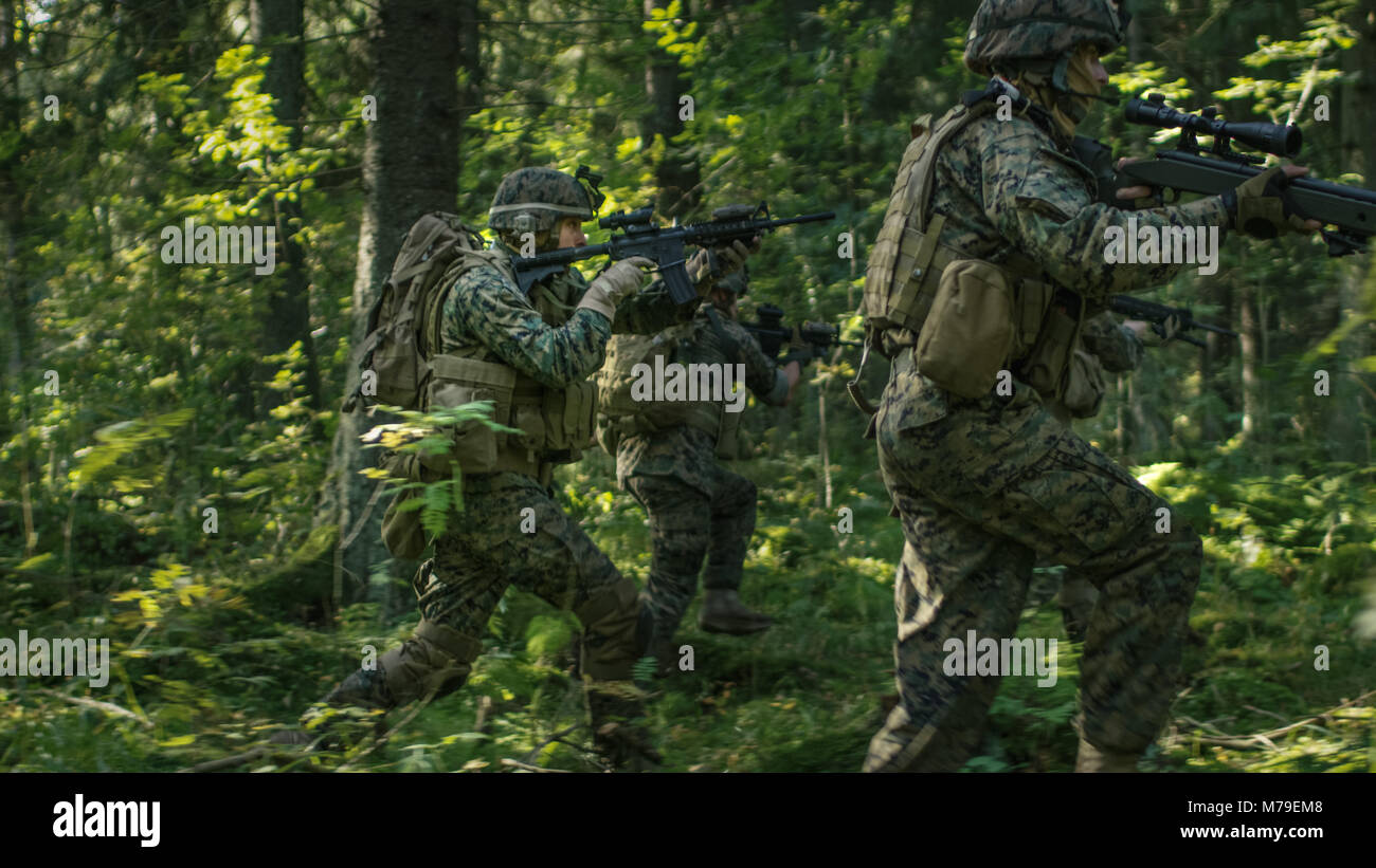 Squad of Fully Equipped Soldiers in Camouflage on a Reconnaissance