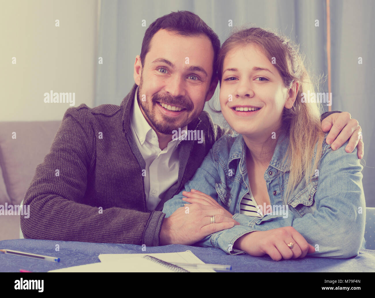 Father helping his child to do homework at home Stock Photo - Alamy