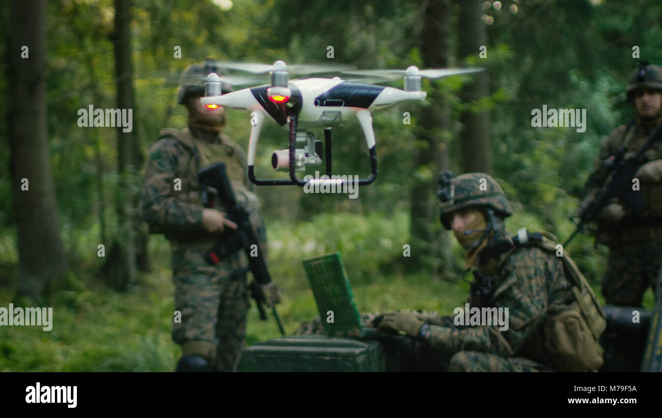 In the Military Staging Base Army Engineer and Soldiers Fly Military Grade Industrial Drone for their Reconnaisance/ Surveillance Mission/ Operation.  Stock Photo