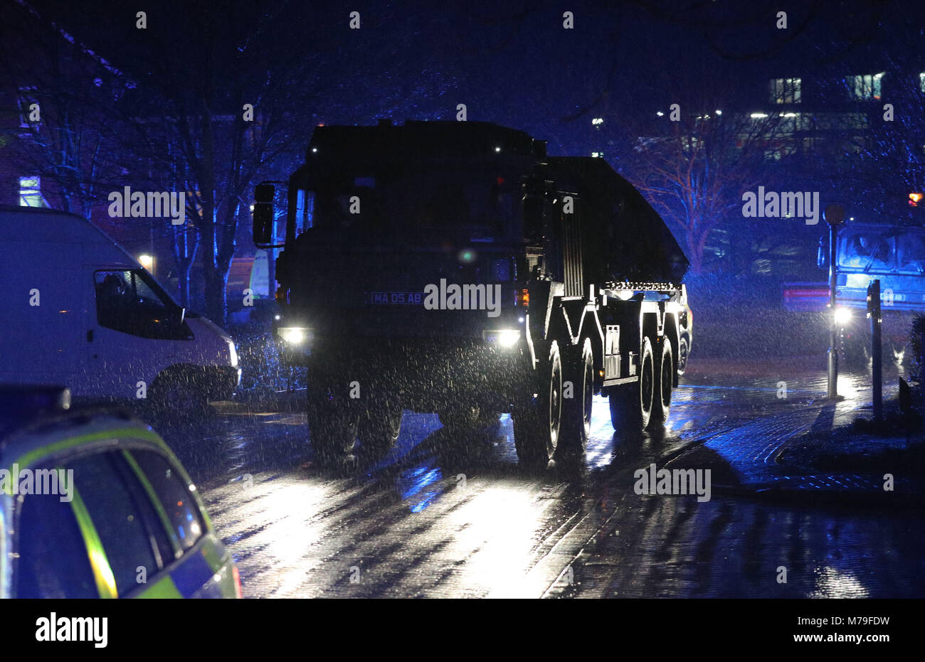 A convoy of police and military vehicles leave Salisbury District Hospital as a police car is taken away as troops have been deployed to help police probing the nerve agent poisoning of spy Sergei Skripal and his daughter. Stock Photo