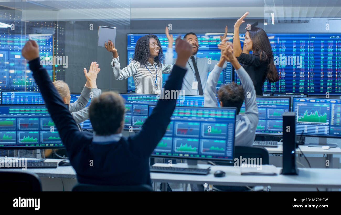 Multi-Ethnic Team of Traders Have Successful Day at the Stock Exchange Office. Dealers and Brokers Celebrate Successful Deal. Stock Photo