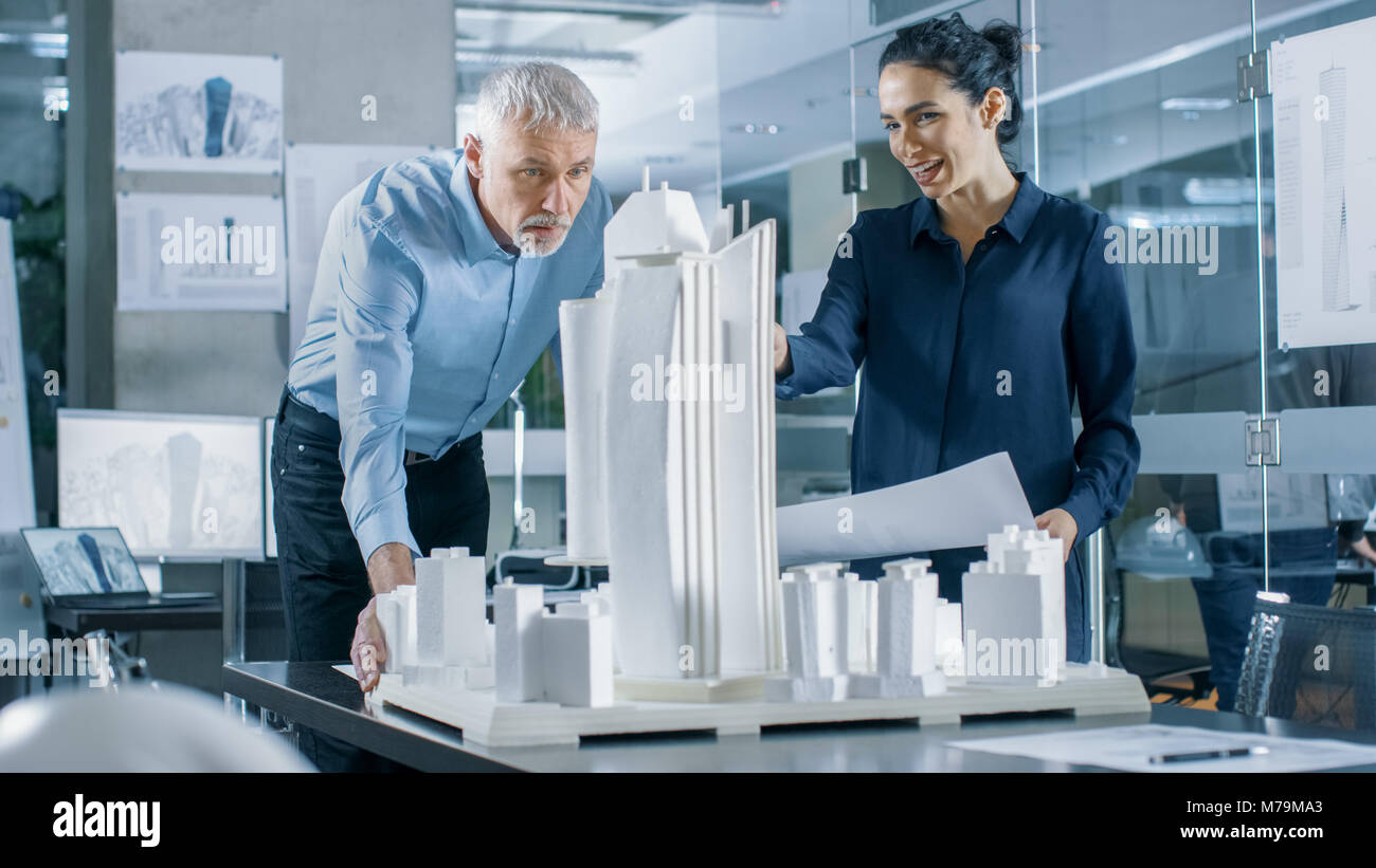 In the Architectural Bureau Two Professional Engineers Work on a Model