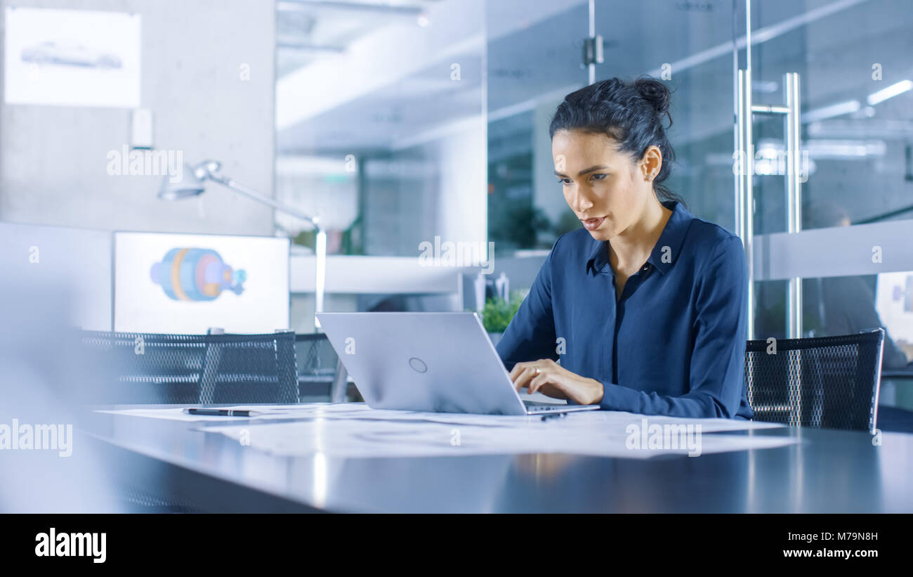 Beautiful Female Data Analyst sitting at the Table Works on a Laptop.  Stylish Woman in the Modern Office Environment Stock Photo - Alamy