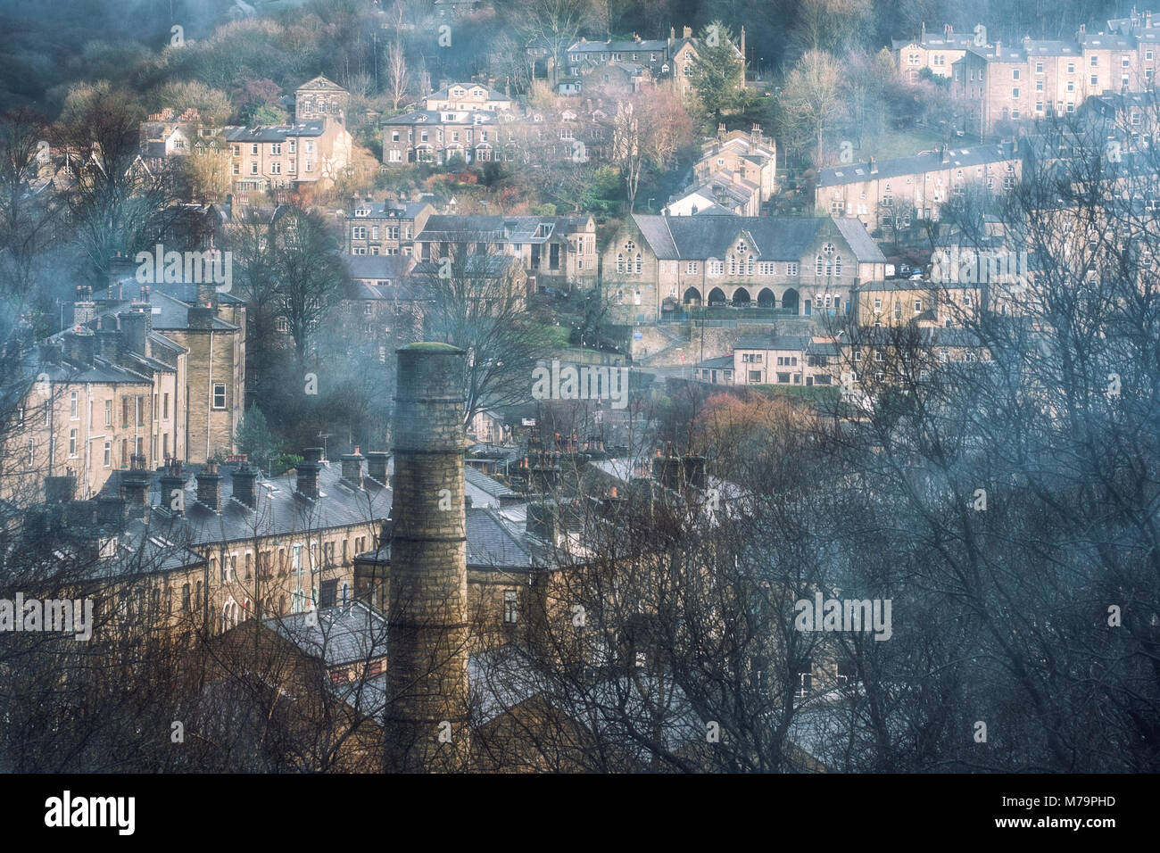 The quaint mill town of Hebden Bridge, West Yorkshire, viewed through smoke on a winters day. Stock Photo