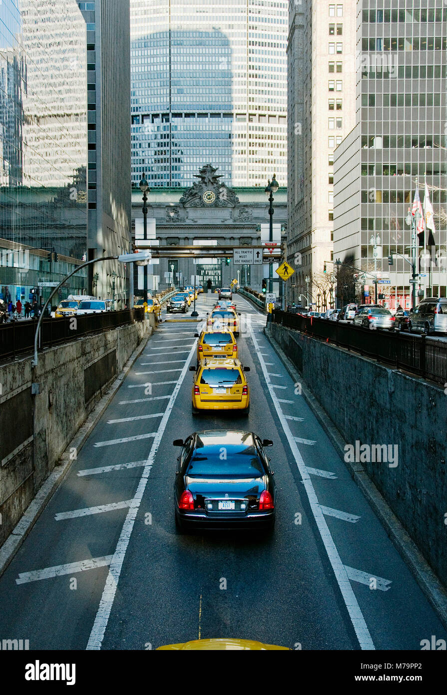 A town car in a line of taxis driving up Park Avenue South towards Grand Central Station. Stock Photo