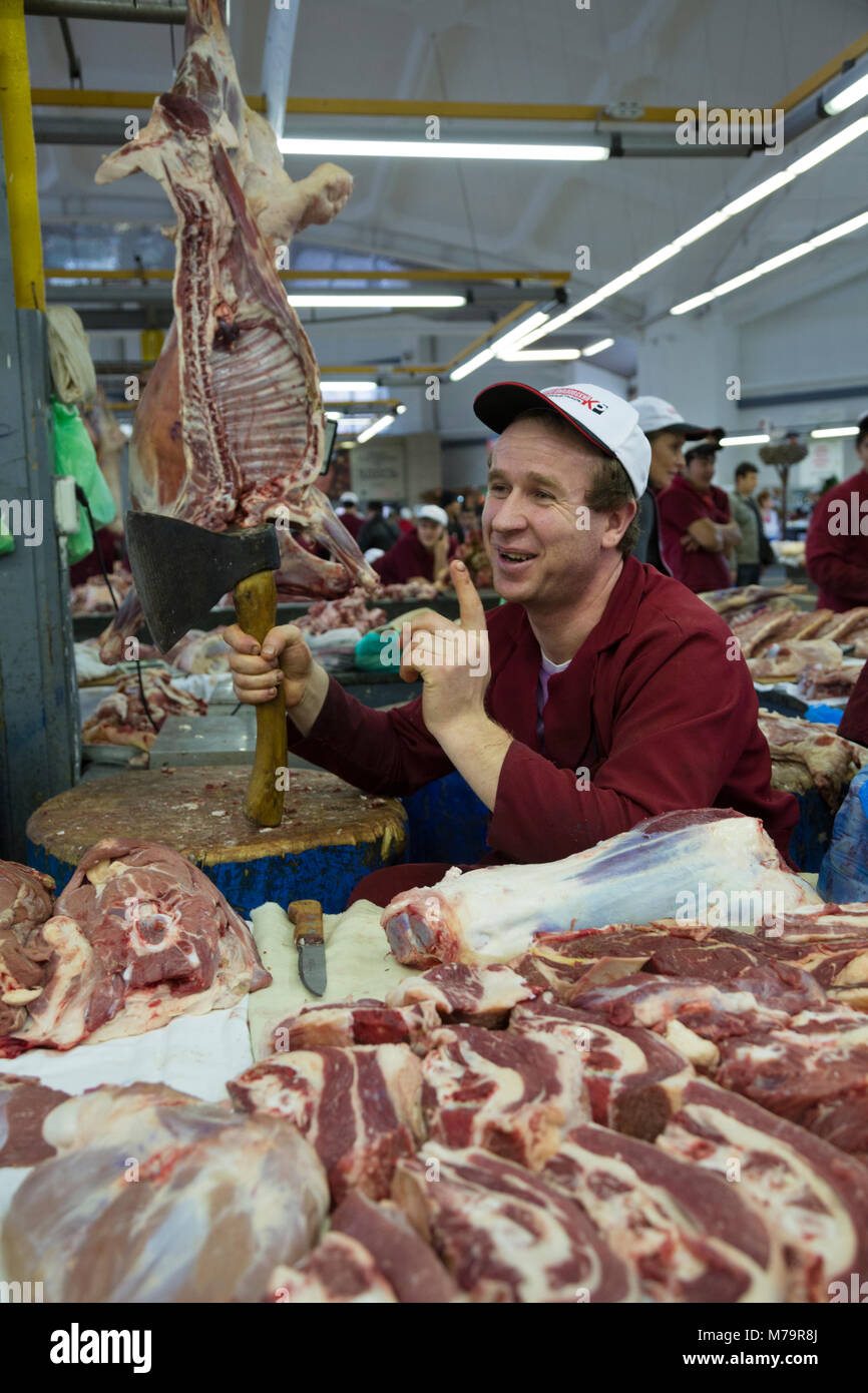 A butcher is traded in the meat range of Dorogomilovskiy market in