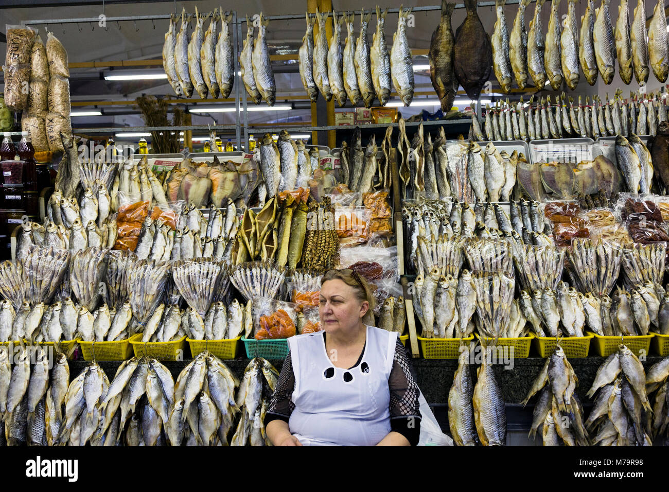 A woman sells dried fish in Dorogomilovsky market in Moscow, Russia ...