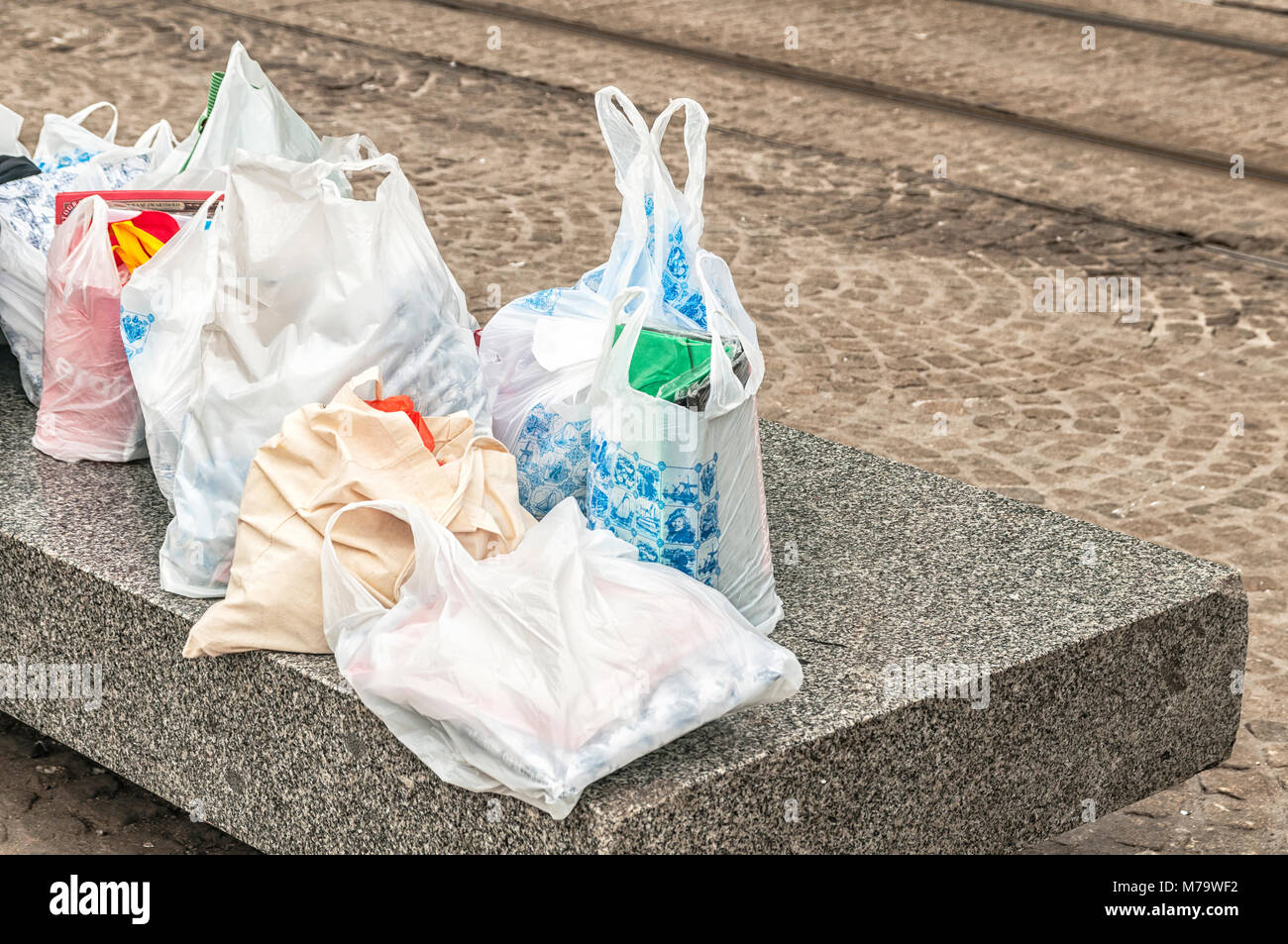 plastic bags lying on a concrete block Stock Photo