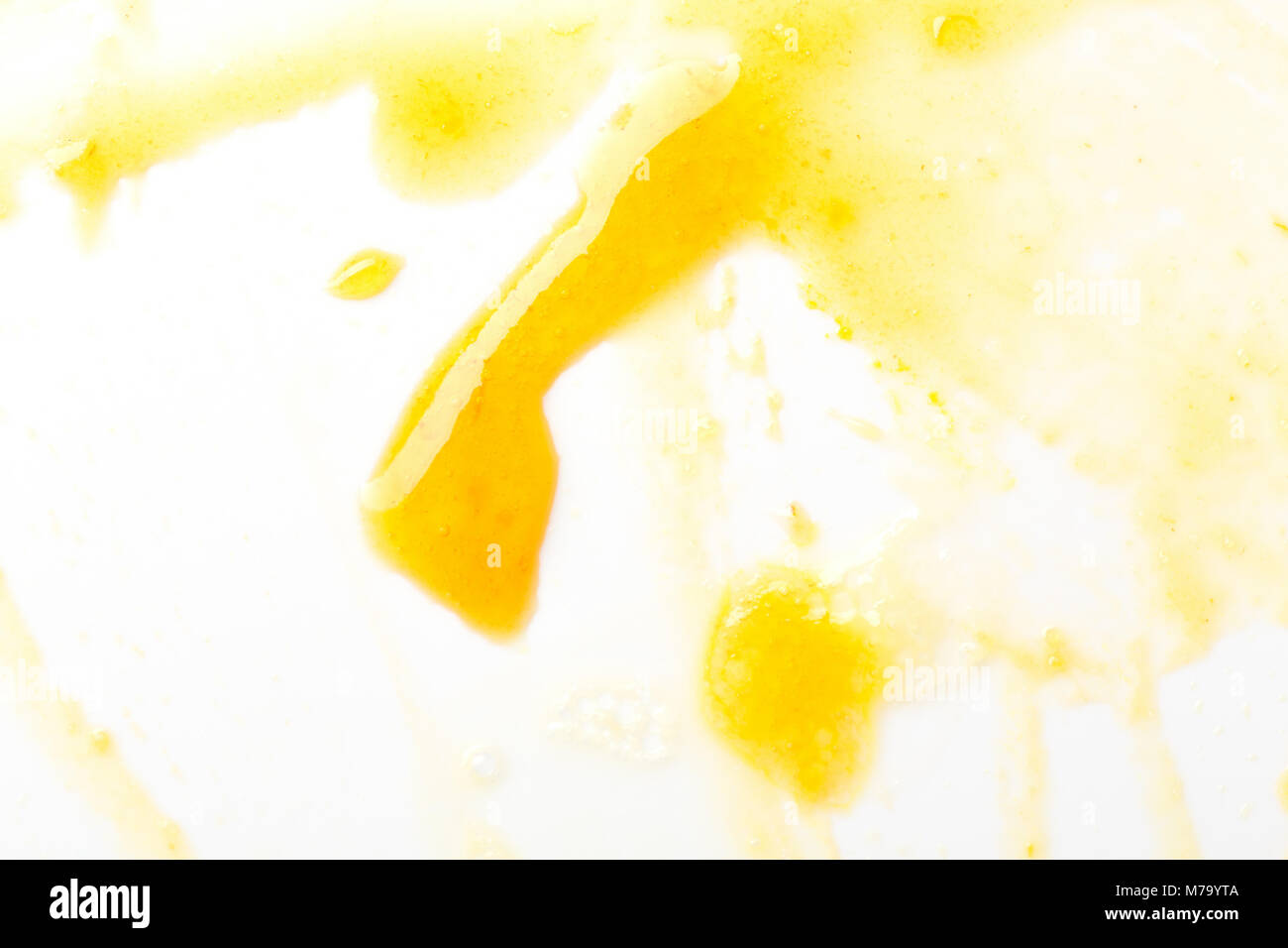 Smeared yellow jam on white. Stock Photo