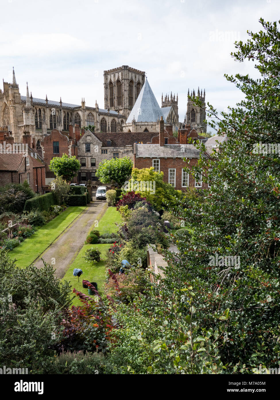 View towards York Minster Cathedral from the city walls and overlooking The Treasurer's House gardens. York. UK Stock Photo