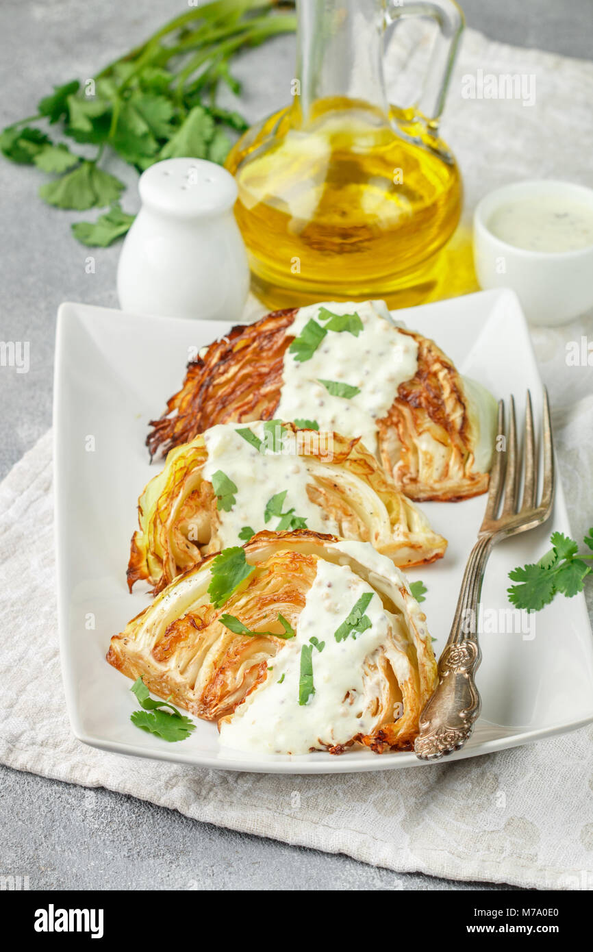 Baked pieces of cabbage with spices and yoghurt sauce, mustard and
