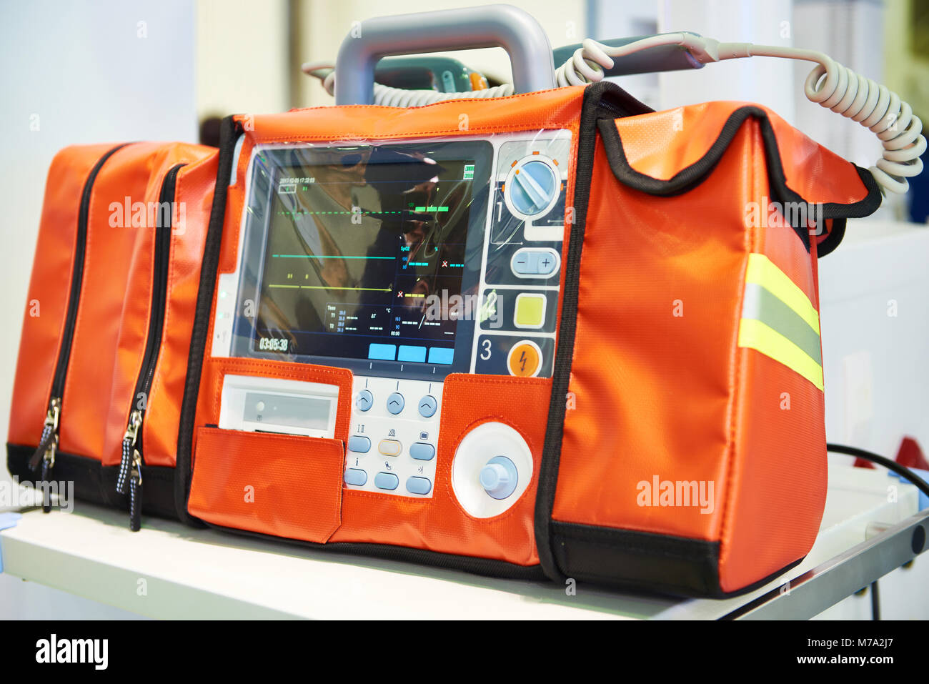 Modern portable biphasic defibrillator in orange bag Stock Photo