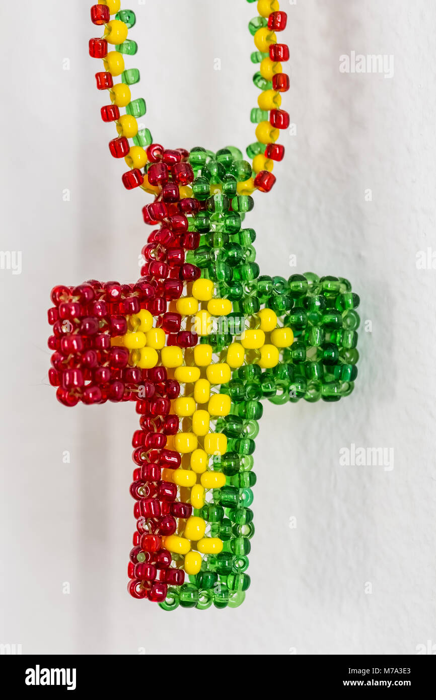 Close up of a Christian Cross made out of Rasta colored beads Stock