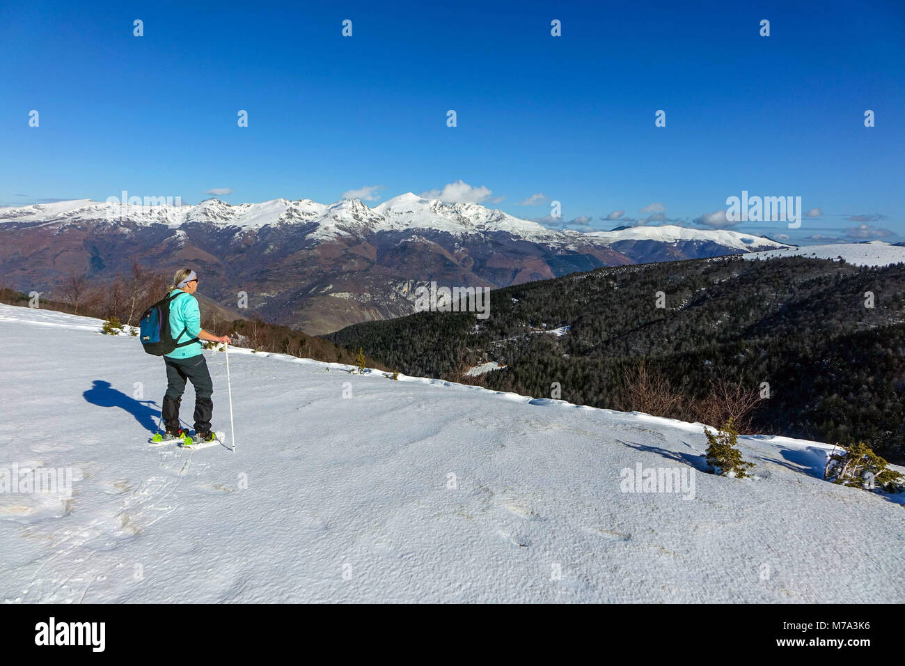 Female snow shoeing, Plateau de Beille, in French Pyrenees, France Stock Photo