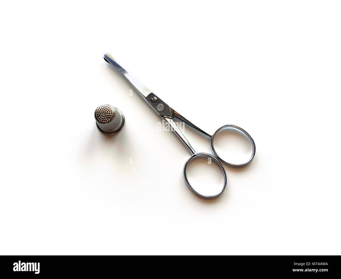 Embroidery scissors and thimble Stock Photo