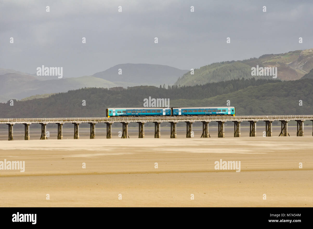 An Arriva Trains Wales train crossing Barmouth Bridge in Wales. Stock Photo