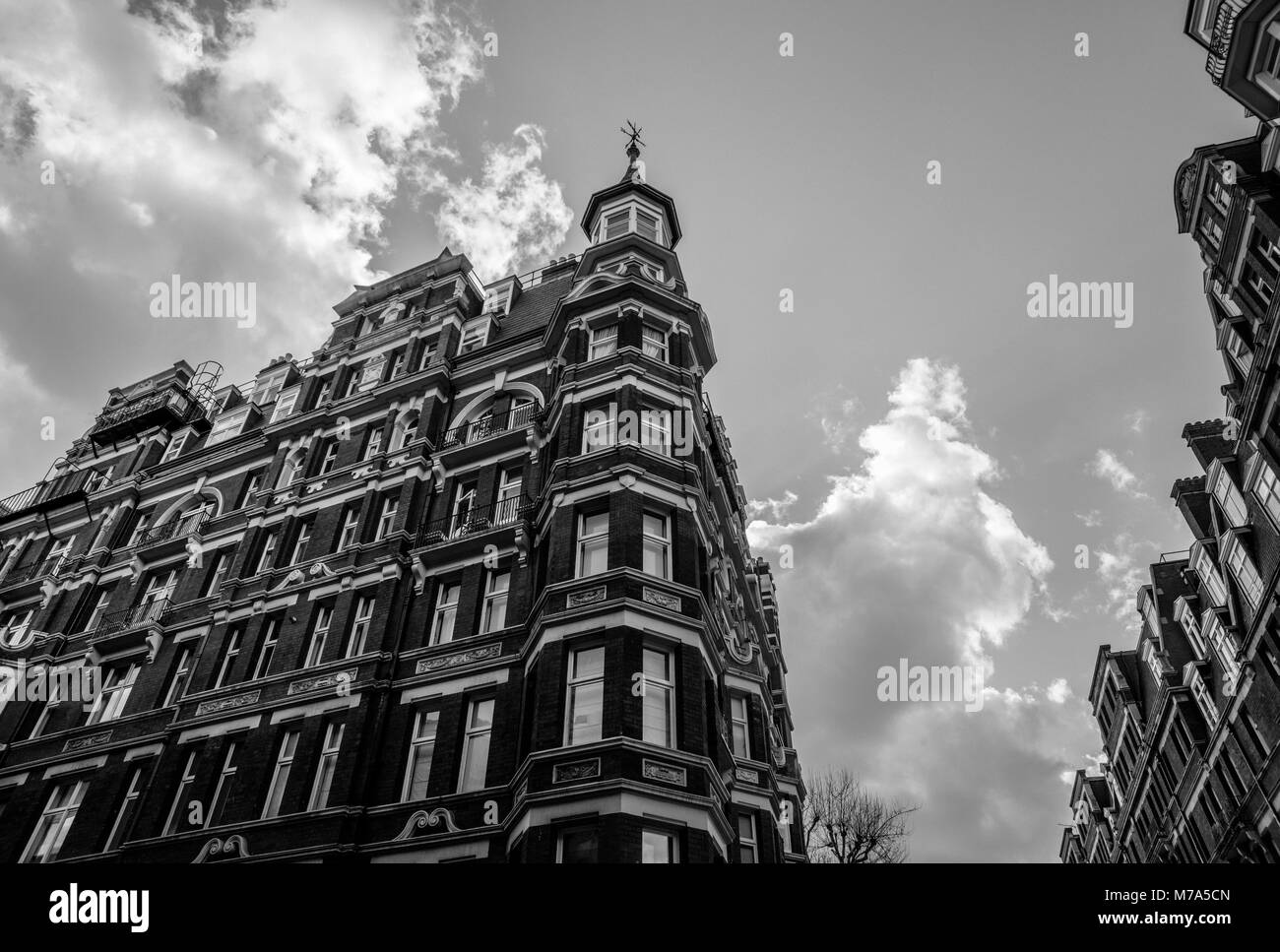 High angle monochrome view looking up at an expensive Edwardian block of period apartments typically found in Kensington, West London, UK Stock Photo