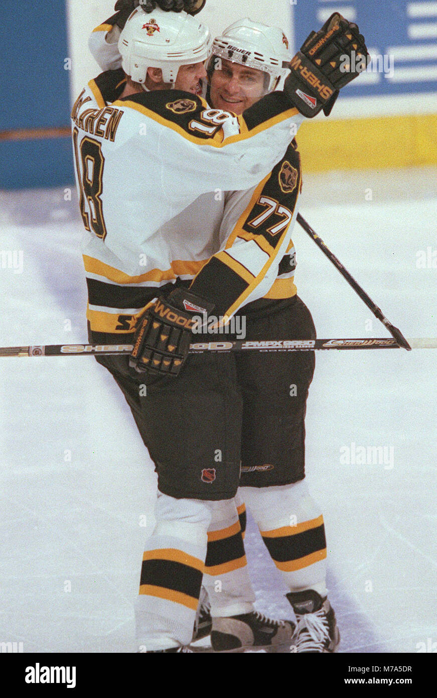 Boston Bruins KYLE MCLAREN HUGS RAY BOURQUE AFTER BOURQUE SCORED THE BRUINS THIRD GOAL on the Chicago Black Hawks at the Fleet Center in Boston Ma USA March 25, 1999 PHOTO BILL BELKNAP Stock Photo