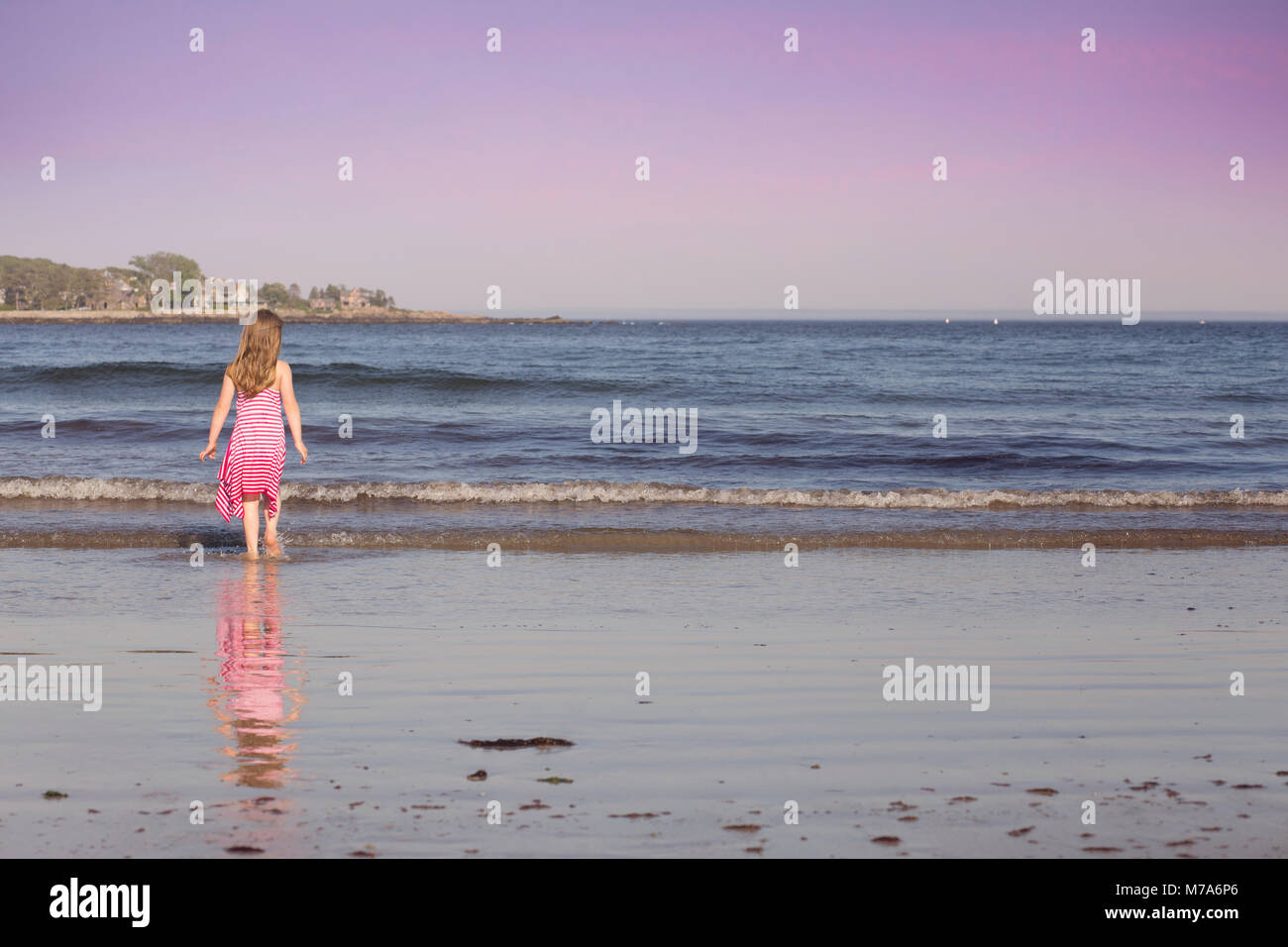 Young Girl Playing on the Beach on a Beautiful Summer Day in Kennebunkport, Maine USA Stock Photo