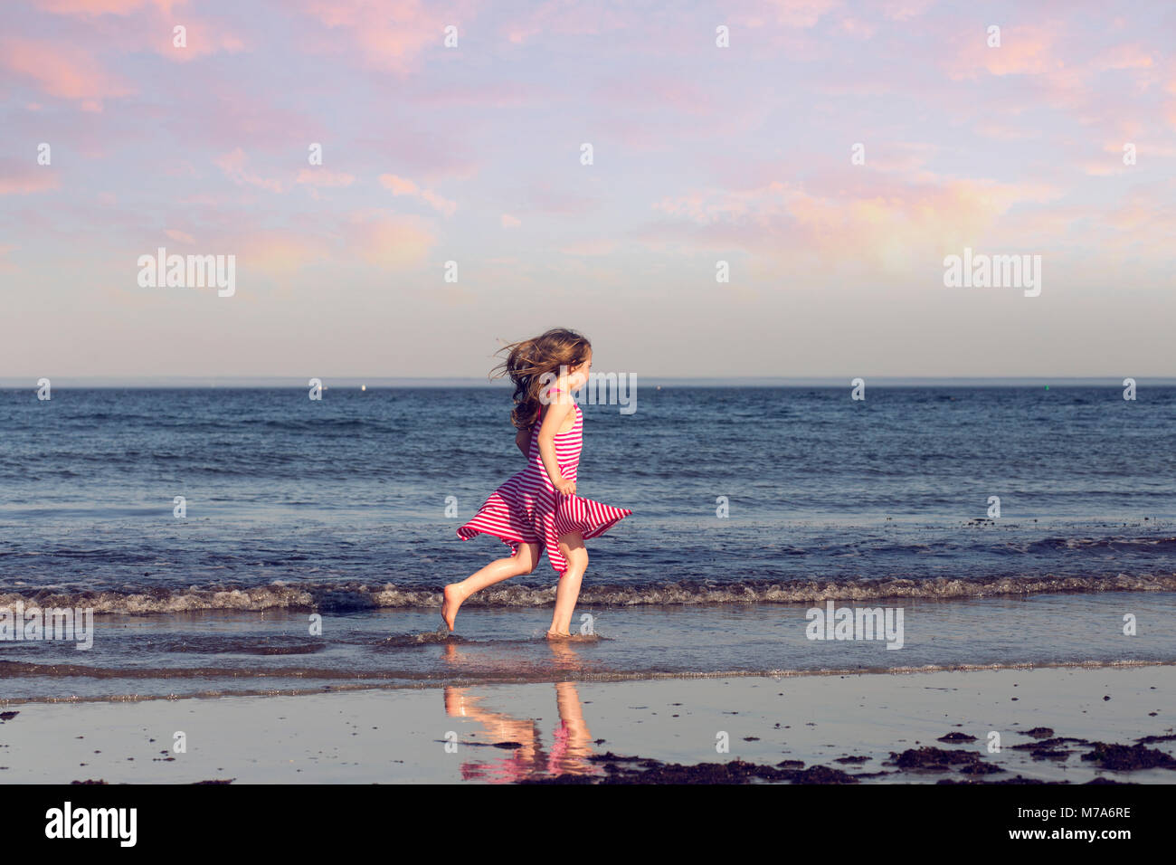 Young Girl Playing on the Beach on a Beautiful Summer Day in Kennebunkport, Maine USA Stock Photo