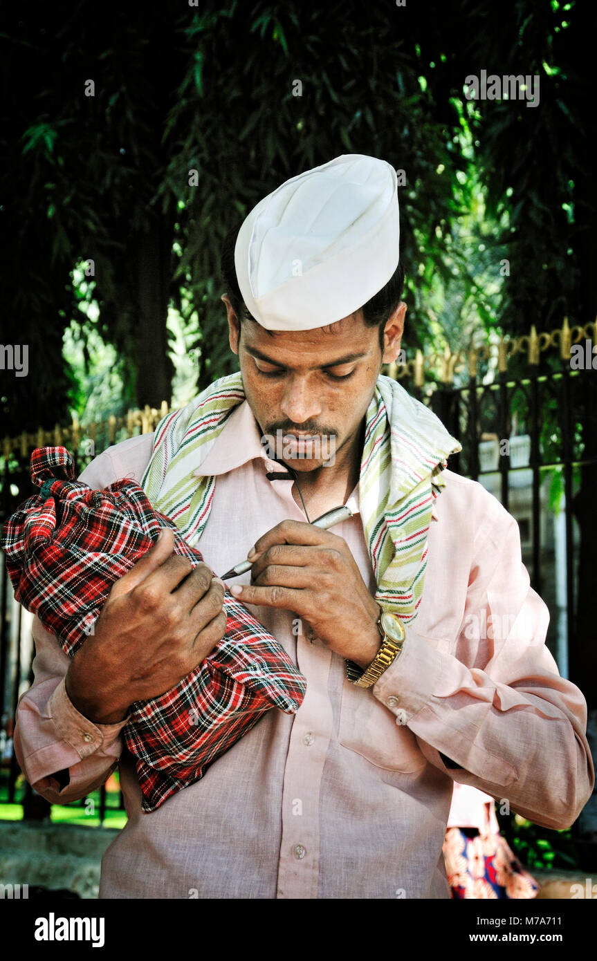 Dabbawala of Mumbai. They collect freshly cooked food from the house of the office workers and deliver it to their respective workplaces and return ba Stock Photo