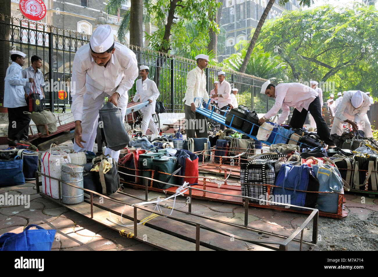 Dabbawalas of Mumbai. They collect freshly cooked food from the house of the office workers and deliver it to their respective workplaces and return b Stock Photo