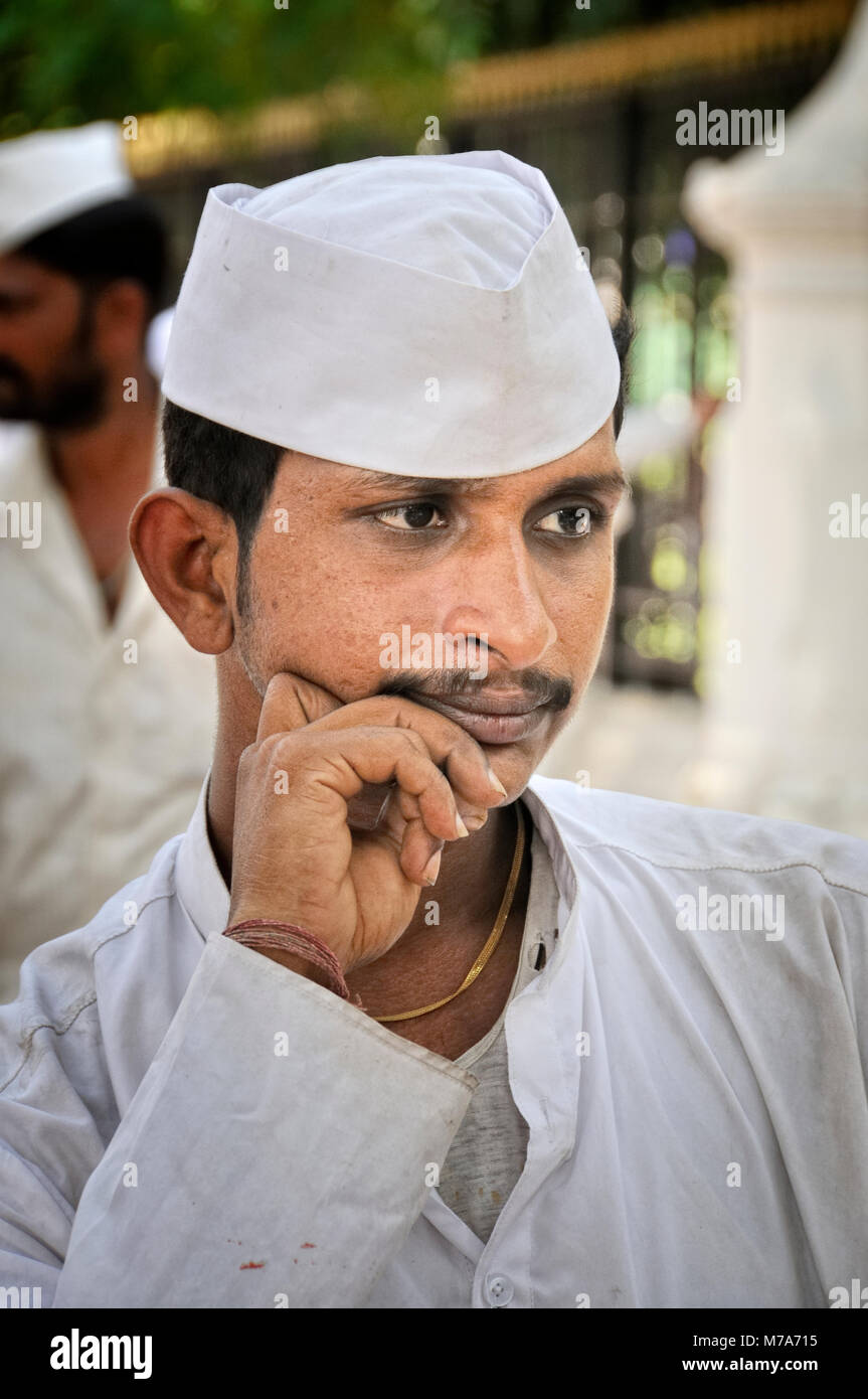 Dabbawala of Mumbai. They collect freshly cooked food from the house of the office workers and deliver it to their respective workplaces and return ba Stock Photo