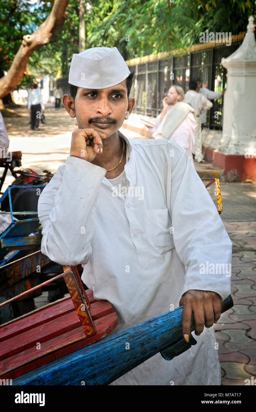 Dabbawala of Mumbai. They collect freshly cooked food from the house of the office workers and deliver it to their respective workplaces and return ba Stock Photo