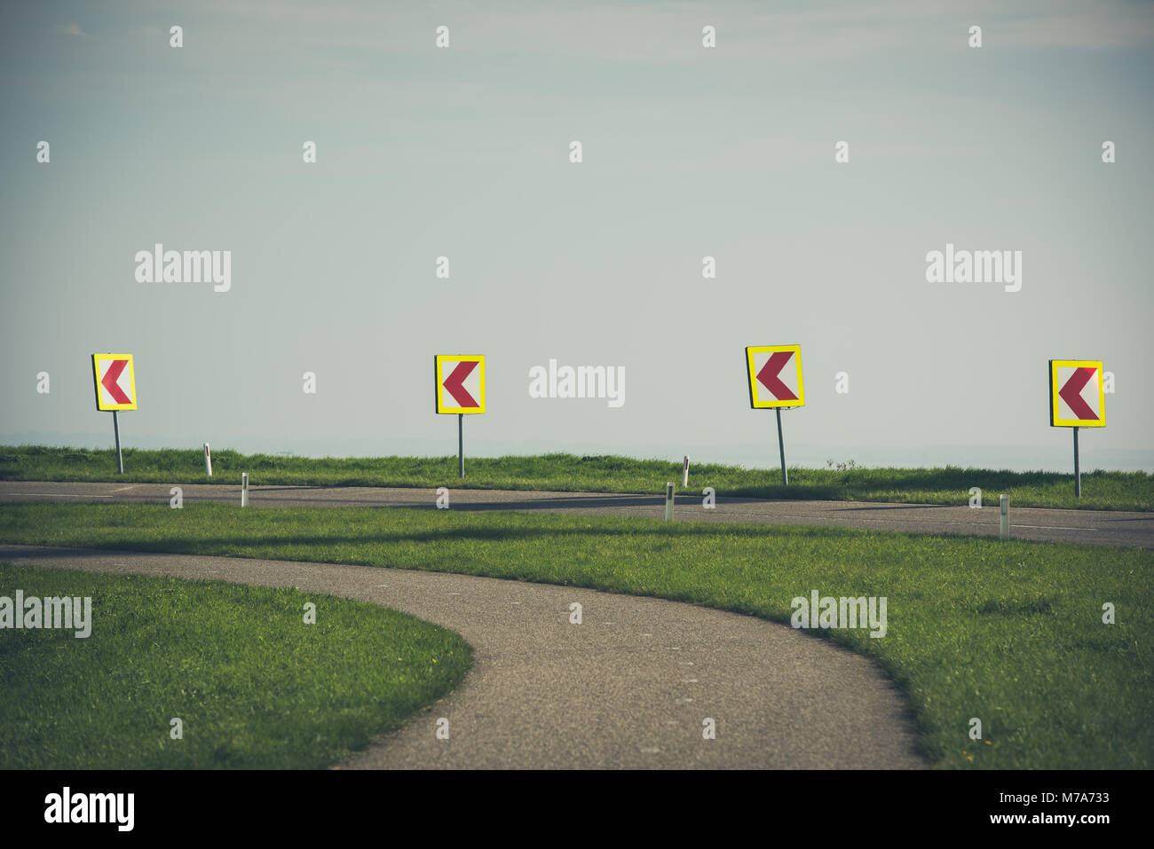 Road signs warning drivers about ahead dangerous curve Stock Photo - Alamy