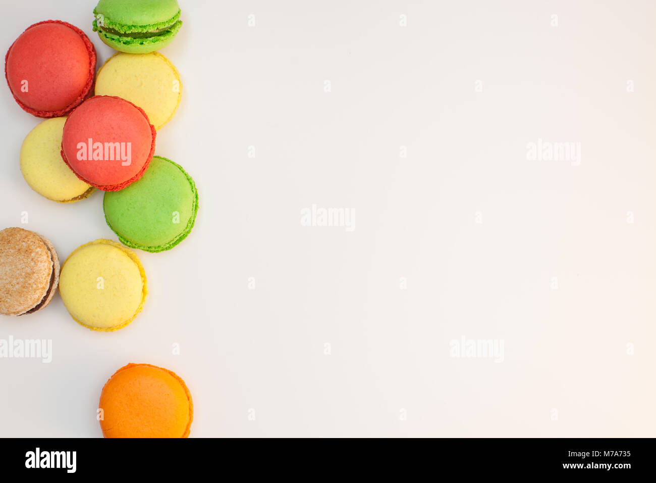 Assorted sweet pastel color macaroons on white background top view. Dessert macaron flat lay. Stock Photo