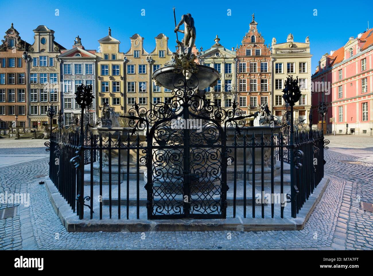 Neptune Fountain and burgher houses with entrance terraces and richly decorated facades at Long Market (part of Royal Route) in Gdañsk at sunrise, Pol Stock Photo