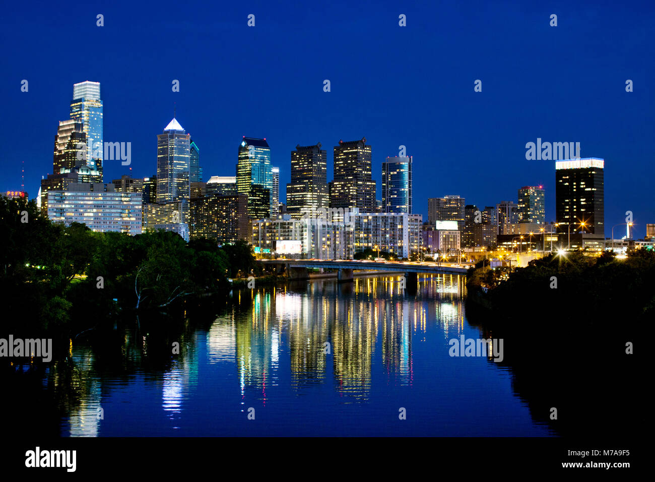 Philadelphia, Pennsylvania, USA skyline at night in black and white with the cities lights reflecting in the water. Stock Photo