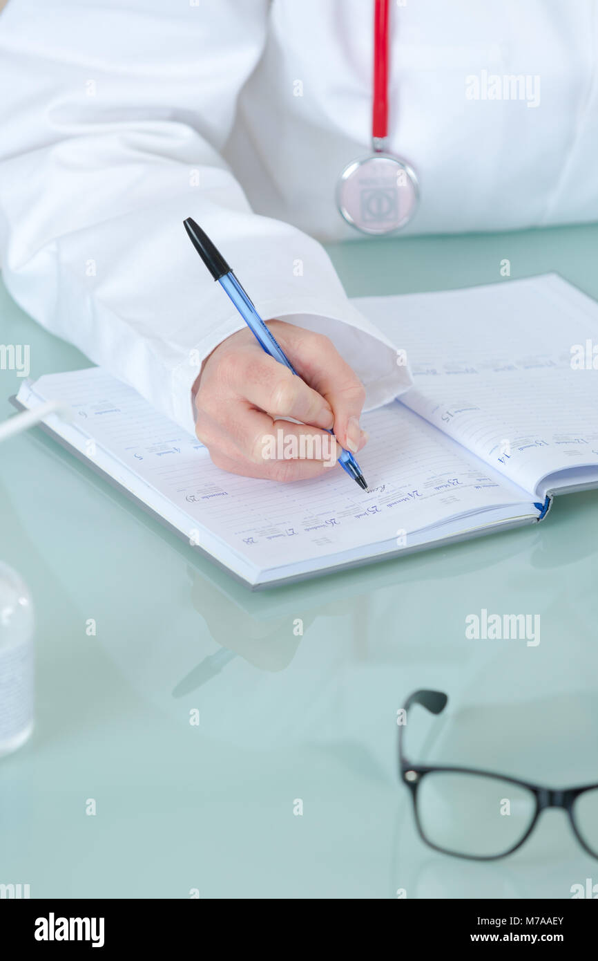 hand of doctor writing on prescription Stock Photo - Alamy