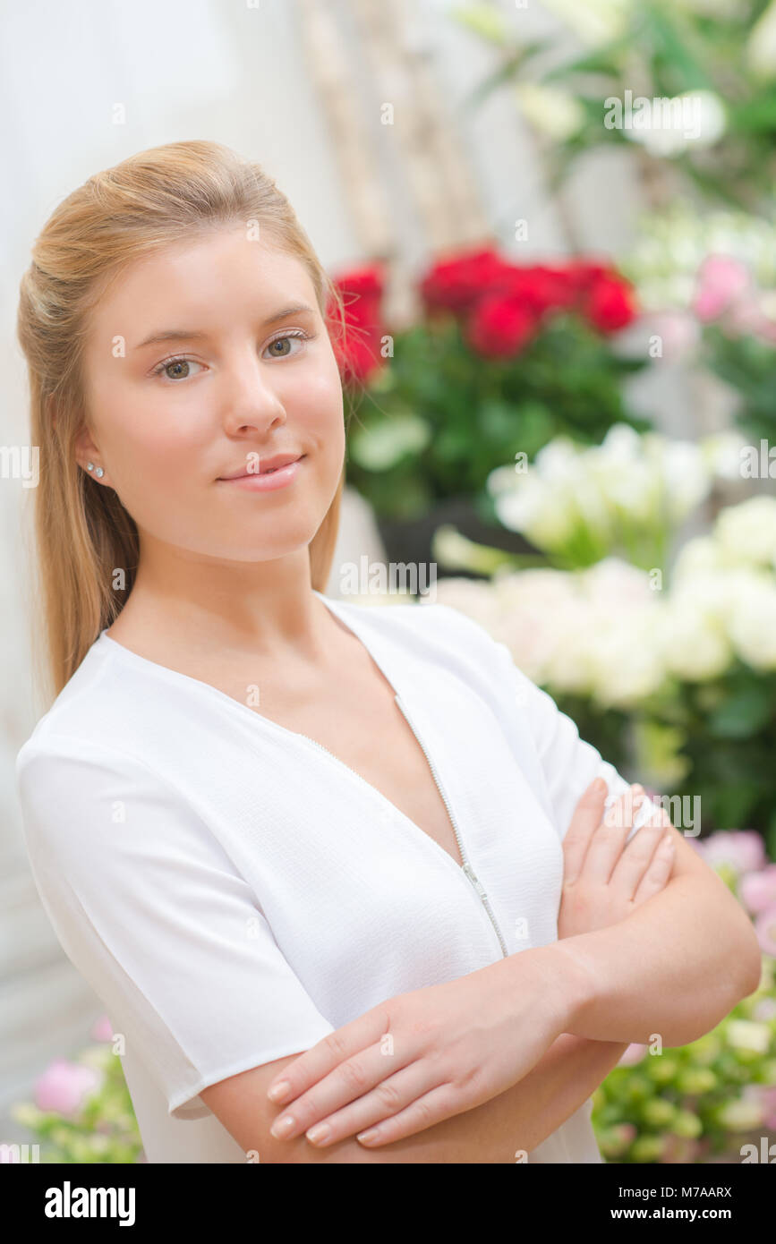 Lady stood in florists, arms crossed Stock Photo Alamy