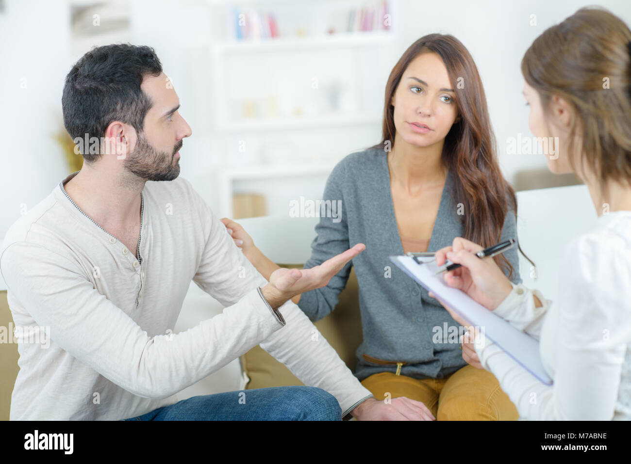 stressed young couple quarrel at the psychologist Stock Photo