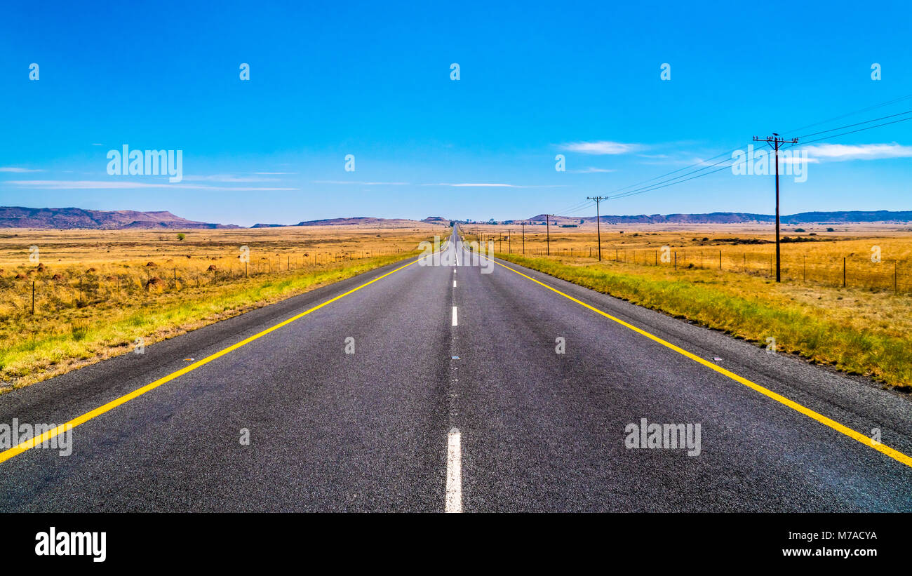 Long Straight Road through the Endless wide open landscape of the semi ...