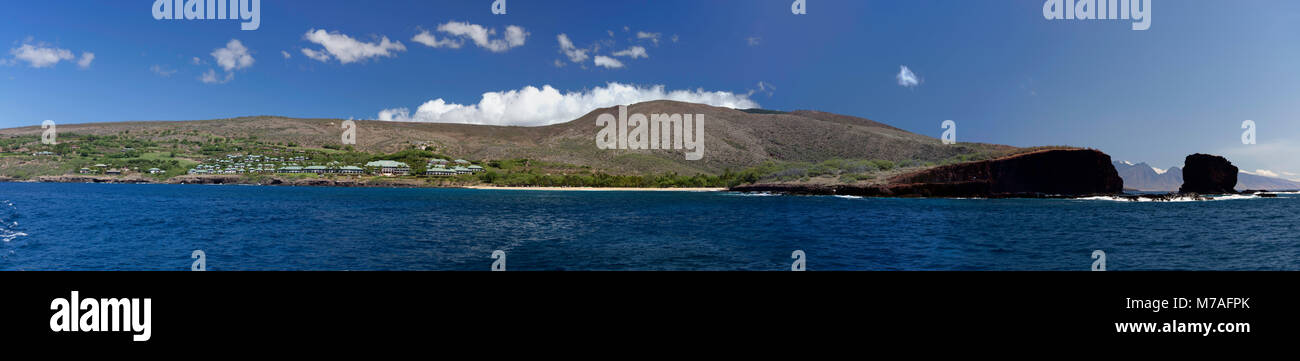 Panorama from the ocean of the Manele Bay Beach Hotel to Pu'u Pehe Rock (Sharks Cove), on the island of Lanai, Hawaii.  The West Maui Mountains can be Stock Photo