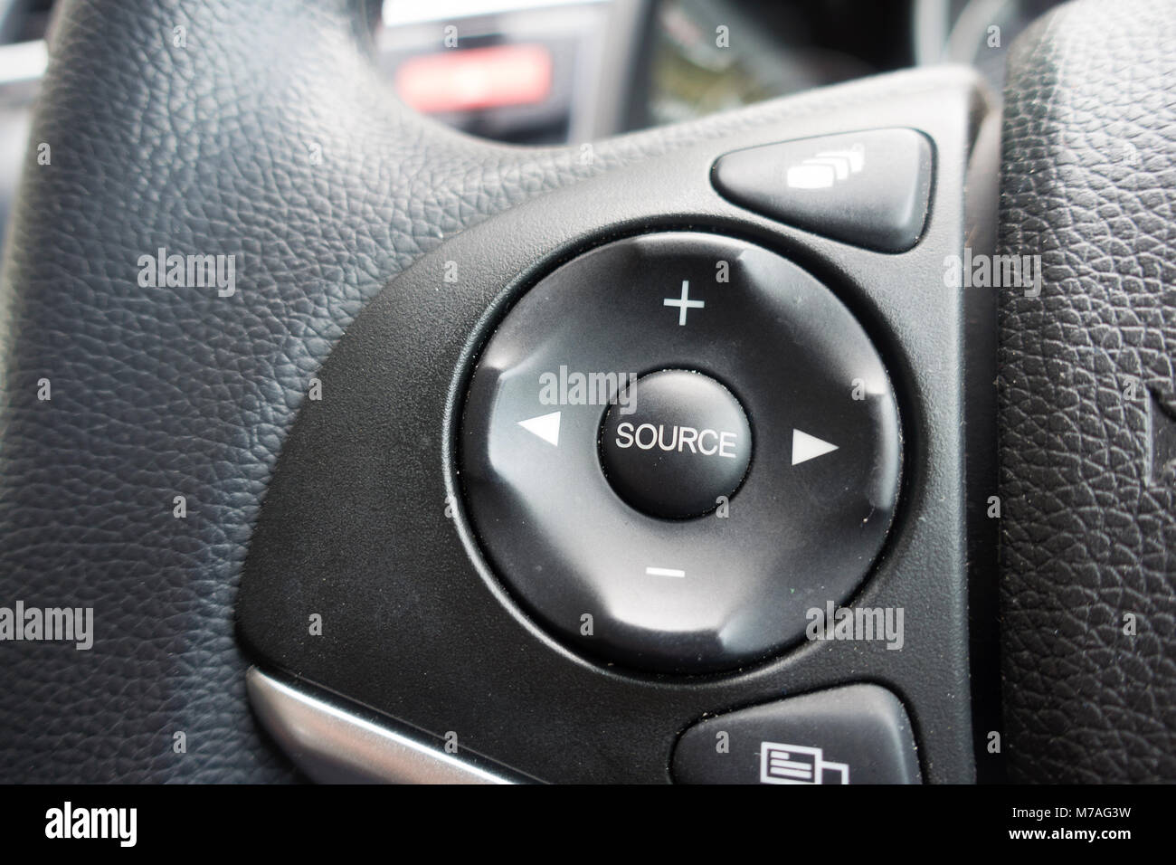 Car stereo controls, built into the steering wheel Stock Photo Alamy