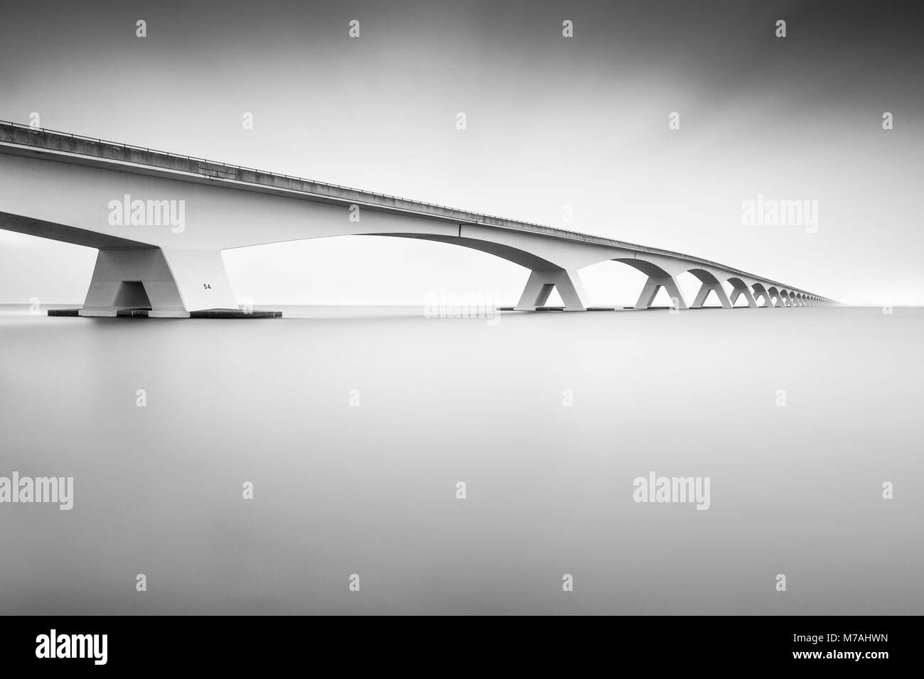The Zeelandbrücke over the Osterschelde in black-and-white long time exposure Stock Photo