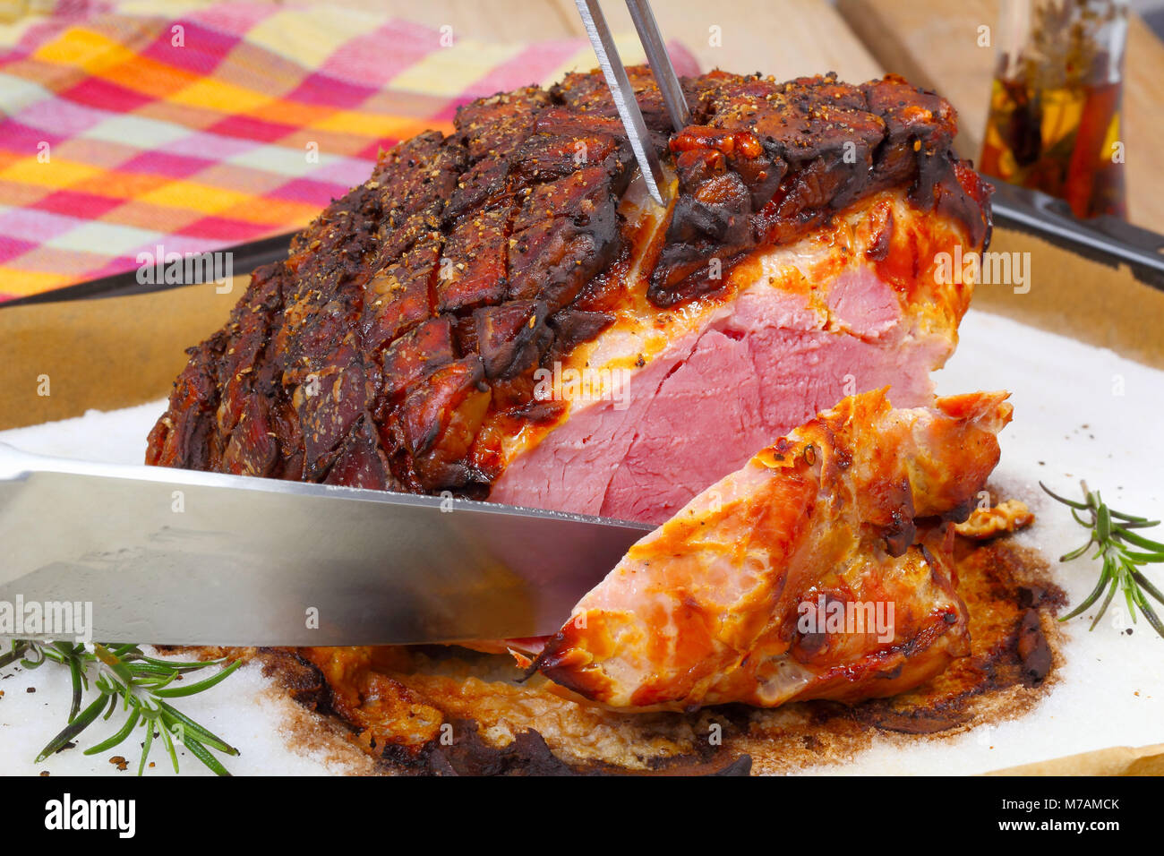 Saltcrusted pork roast is cut Stock Photo Alamy