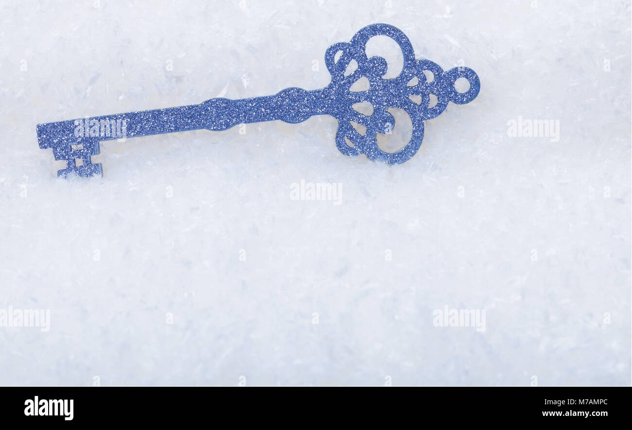 Silver key in  the snow Stock Photo