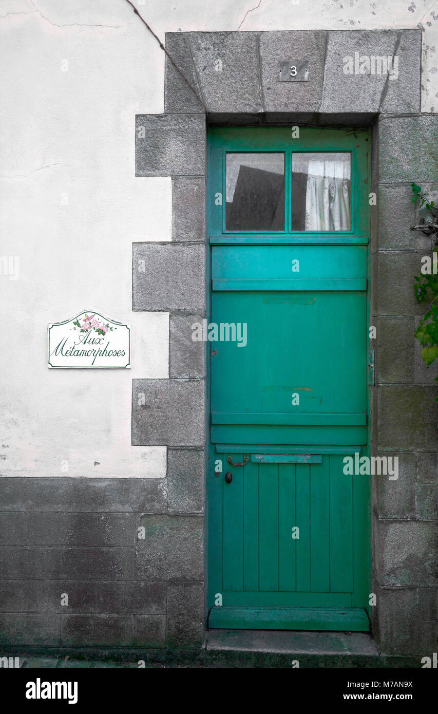 Door sign 'Aux metamorphoses' with green door Stock Photo