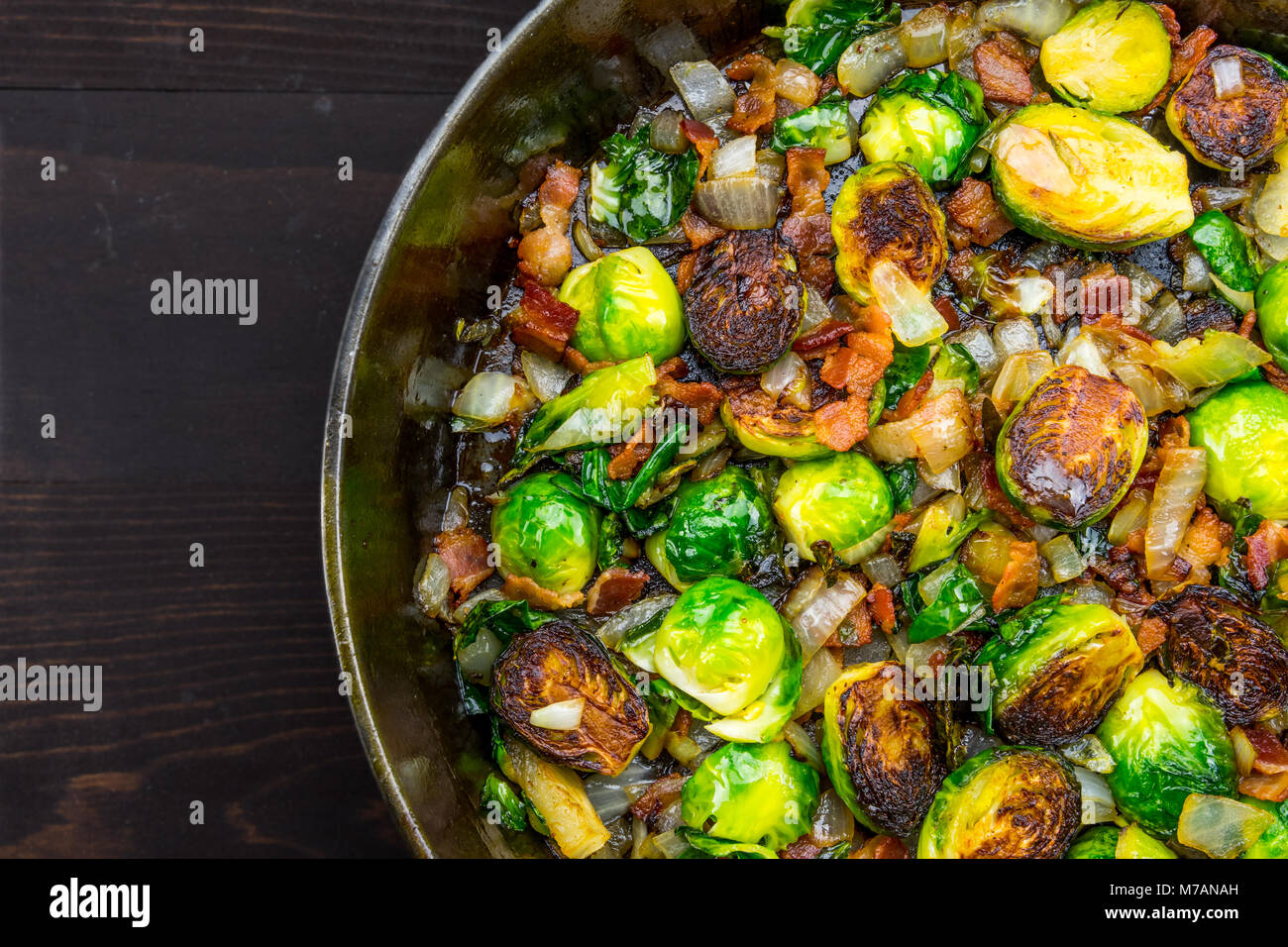 Cast Iron Skillet with Brussels Sprouts with sliver of table background Stock Photo Alamy