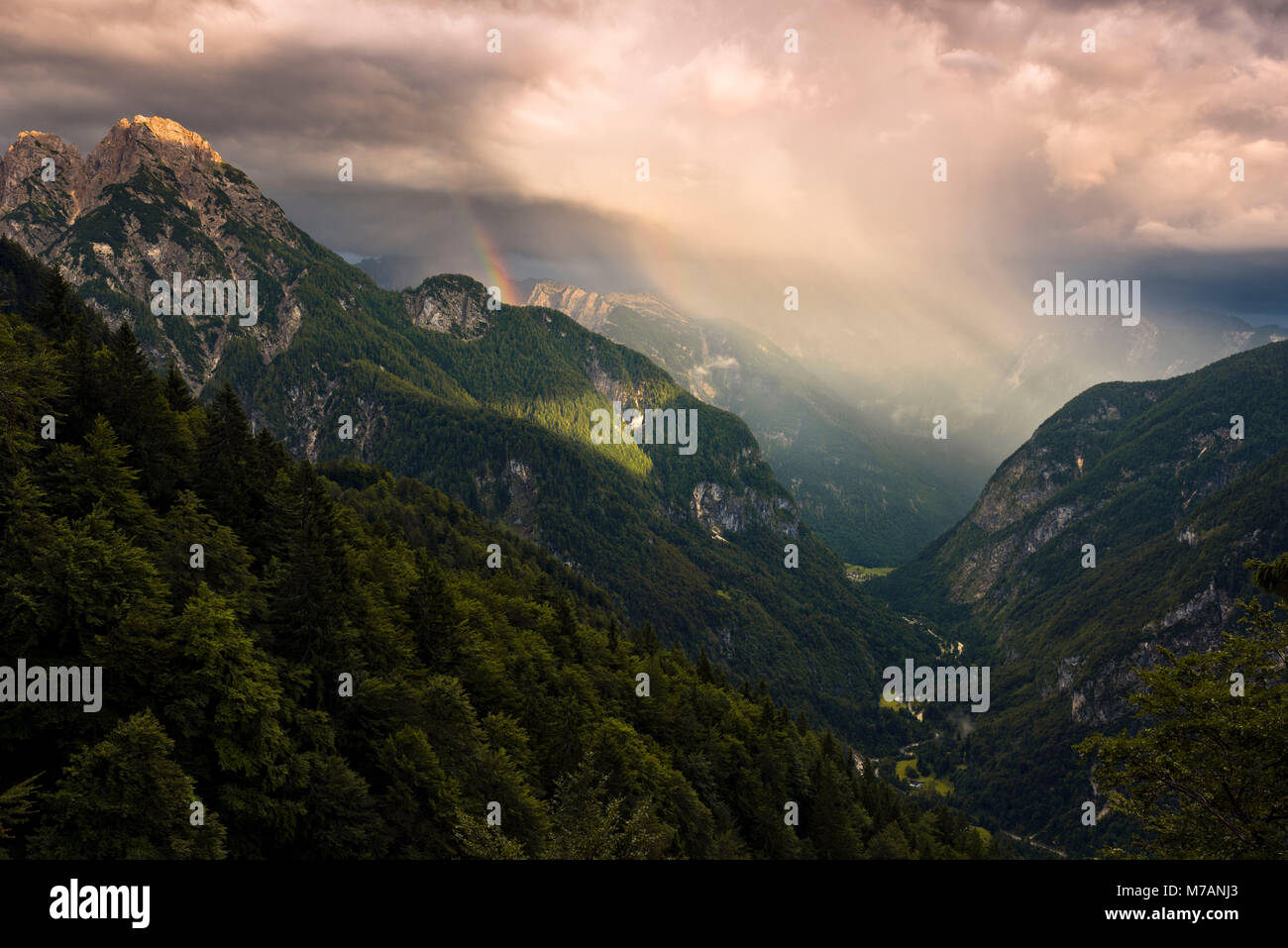 View into the valley of Trenta in majestic evening light with rainbow, Kanjavec summit, Mali Spicje, Velika Ticharica, Triglav National Park, Slovenia Stock Photo