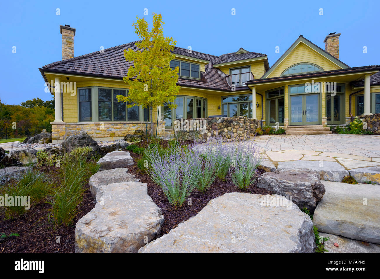 wood house exterior with stone landscaping Stock Photo